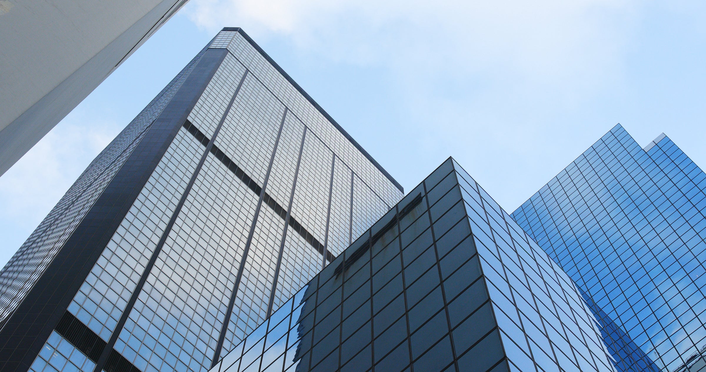 Tall glass skyscrapers against a clear blue sky